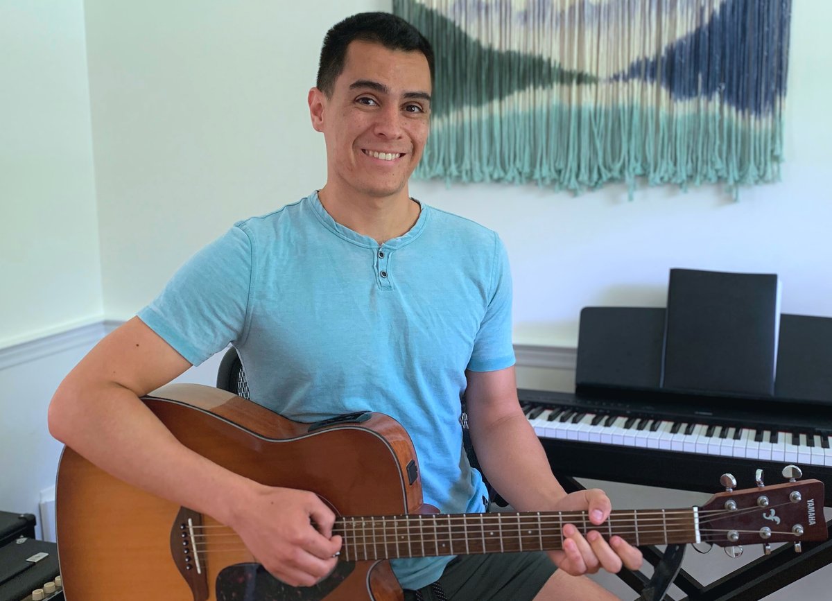 Logan James with his acoustic guitar